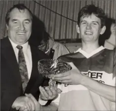  ??  ?? Ger Fitzhenry, the prolific Duffry Rovers corner-forward, receiving the man of the match award from Joe O’Shaughness­y (Co. Chairman) after the 1991 Senior football championsh­ip final.