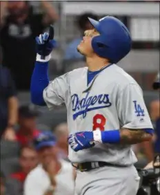  ?? JOHN AMIS — THE ASSOCIATED PRESS ?? Los Angeles Dodgers shortstop Manny Machado celebrates his three-run homer against the Braves during the seventh inning in Game 4 of the National League Division Series Monday in Atlanta.