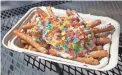  ?? ANDY BLYE ?? Fried dough fries with whipped cream and Fruity Pebbles from Nurdberger in Gilbert.
