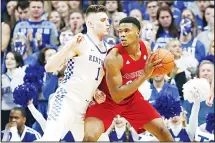  ?? (AP) ?? Louisville’s Steven Enoch (right), looks for an opening on Kentucky’s Nate Sestina during the first half of an NCAA college basketball game in Lexington, Kentucky on Dec 28.
