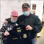  ??  ?? Brady Spivey, a seventh-grade agricultur­e student of John E. King’s sold $1,000 worth of Blue & Gold Sausage, was presented his FFA jacket by teacher Perry Mason.