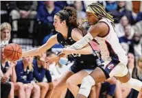  ?? Jessica Hill/Associated Press ?? Villanova’s Maddy Siegrist, left, is pressured by UConn’s Aaliyah Edwards in the second half in the Big East tournament final at Mohegan Sun Arena on March 7 in Uncasville.