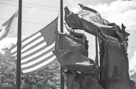  ?? PHOTOS BY ADAM CAIRNS/COLUMBUS DISPATCH ?? First Responders Park in Westervill­e features pieces of twisted metal from the World Trade Center.