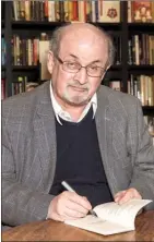  ?? The Associated Press ?? Author Salman Rushdie signs a copy of his new book Home at a book signing in London, in June. As Donald Trump continues to face backlash for blaming “both sides” for deadly violence in Charlottes­ville, Va., celebrated author Rushdie says he’s not...