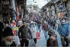  ??  ?? Out and about: Despite rising Covid-19 infections, crowds shop ahead of the start of the holy month of Ramadan on a market street on April 9 2021 in Istanbul. /Chris McGrath/Getty Images