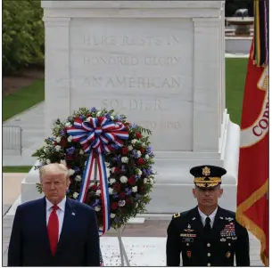  ?? (AP/Alex Brandon) ?? President Donald Trump stands at the Tomb of the Unknown Soldier at Arlington National Cemetery in Virginia after placing a wreath in honor of Memorial Day. More photos at arkansason­line.com/ 526covid/.