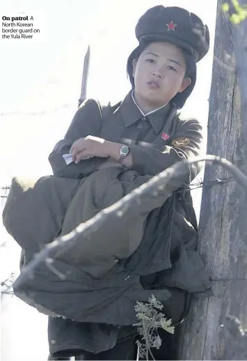  ??  ?? On patrol A North Korean border guard on the Yula River