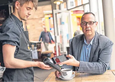  ??  ?? Colin Munro, managing director of Miconex, receives some loyalty points with his coffee.