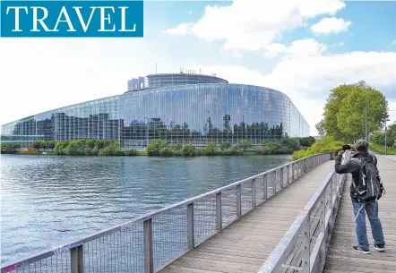  ?? PHOTOS BY ALBERT STUMM VIA AP ?? A tourist takes a picture of the European Parliament building in Strasbourg, France. The body is one of many internatio­nal organizati­ons based in the Alsatian city that has strong roots in both French and German culture.