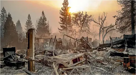  ?? AP ?? A vintage car rests among debris as the Camp Fire tears through Paradise, California, yesterday.