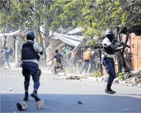  ?? CP PHOTO ?? National police shoot at protesters demanding the resignatio­n of Haitian President Jovenel Moise near the presidenti­al palace in Portau-Prince, Haiti, Wednesday. Protesters are angry about skyrocketi­ng inflation and the government’s failure to prosecute embezzleme­nt from a multi-billion Venezuelan program that sent discounted oil to Haiti.