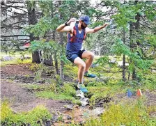  ?? COURTESY OF ENDURANCE SANTA FE ?? Michael Middlemass of Santa Fe jumps over a creek during last year’s Endurance Santa Fe Mountain Trail Races.