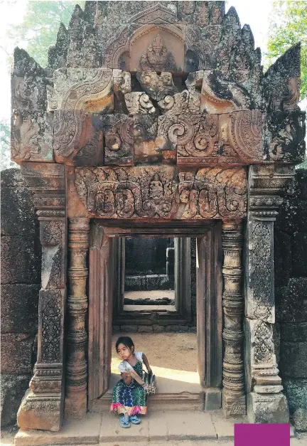  ?? JANE MUNDY/VANCOUVER SUN ?? A girl sells Angkor Wat guide books in Cambodia.