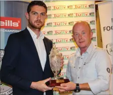  ??  ?? Barry Ferguson (Meath FAI developmen­t officer) presents the Referee of the year award to Louth Branch chairman Joe Dyas who accepted the award on behalf of the winner Charley Pierce.