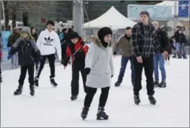  ?? CARLOS OSORIO — THE ASSOCIATED PRESS ?? People skate at the Campus Martius ice rink in Detroit. Some cities and regions are dangling racial diversity along with positive business climates, competitiv­e tax rates and available land in pitches to lure tech companies and high-paying jobs to...