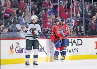  ?? [NICK WASS/THE ASSOCIATED PRESS] ?? Washington Capitals center Evgeny Kuznetsov celebrates his goal with left wing Alex Ovechkin, right, during the second period Tuesday as Minnesota Wild center Eric Staal looks on in Washington. BLACKHAWKS 4, CANADIENS 2: