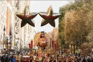  ?? Jeenah Moon / Associated Press ?? The Tom Turkey float leads the way down Central Park West in New York during the Macy’s Thanksgivi­ng Day Parade on Thursday.