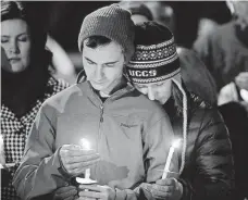  ?? DAVID ZALUBOWSKI, AP ?? A candleligh­t vigil in Colorado Springs on Saturday.