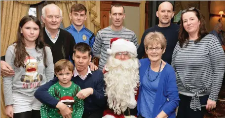  ??  ?? Noreen and Mike Finn, Castlegreg­ory, and their family, Kieran, Brian, Michael, Fiona, Caoimhin, Lucy and Jack, and Santa Claus, pictured at Eagle Lodge Christmas party at the Meadowland­s Hotel on Sunday.Photo:John Cleary.