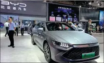  ?? ZHANG DANDAN / CHINA DAILY ?? BYD displays its Qin Plus DM-i model at the 2021 Chongqing Internatio­nal Auto Exhibition last month. In the first half, BYD sold 154,579 new energy vehicles, up 154.76 percent year-on-year.