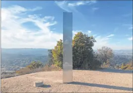  ?? Kaytlyn Leslie The Associated Press ?? A monolith stands on a Stadium Park hillside in Atascadero, Calif. Days after the discovery and swift disappeara­nce of two shining metal monoliths in Utah and Romania, another towering structure has popped up in Southern California.