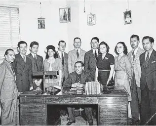  ?? National Museum of American History/Smithsonia­n Institutio­n ?? Pioneering Spanish-language broadcaste­r Raoul A. Cortez Sr., seated, gathers KCOR staff in the late 1940s, when the station was the first to program full time to a Latino audience.