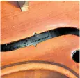  ??  ?? Pte Howard, left, and, above, his craftsman’s signature inside the violin, which prompted its owner to investigat­e