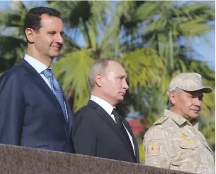  ?? (Mikhail Klimentyev/Sputnik/Reuters) ?? RUSSIAN PRESIDENT Vladimir Putin is flanked by Syrian President Bashar Assad (left) and Russian Defense Minister Sergei Shoigu at Hmeymim Air Base in Syria last week.