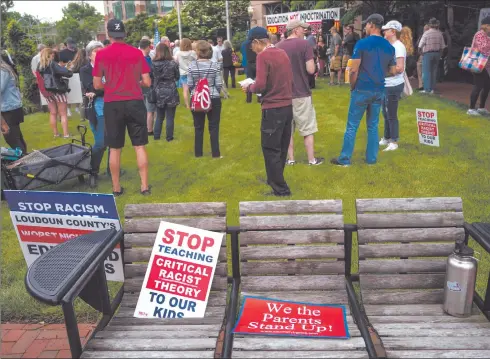  ?? Photo: Nampa/AFP ?? Race... The recent dismissal of a white New York professor for reading aloud the “N-word” from a Mark Twain novel has shone a spotlight on the use of racial slurs in American classrooms. In this file photo taken on 12 June 2021, signs sit on a bench during a rally against “critical race theory” (CRT) being taught in schools at the Loudoun County Government centre in Leesburg, Virginia.