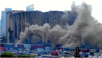  ?? AP ?? Dust rises from silos in the port of Beirut, Lebanon,after a section of the massive port grain silos collapsed.