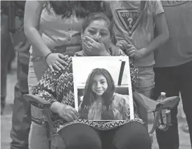  ?? JAE C. HONG/AP ASSOCIATED PRESS ?? Esmeralda Bravo, 63, cries while holding a photo of her granddaugh­ter, Nevaeh, one of the shooting fatalities at Robb Elementary School Uvalde, Texas.