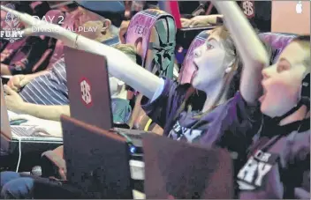  ?? AP PHOTO ?? In this Nov. 17 image provided by Super League Gaming, New York Fury team competitor­s react during a Super League Gaming competitio­n against a team from Boston at City Center 15 Cinema de Lux in White Plains, N.Y.