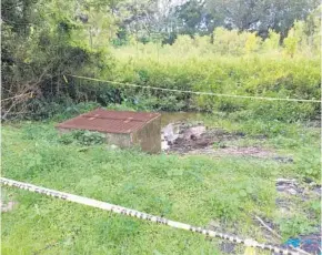  ?? RYAN GILLESPIE/STAFF ?? Part of Lake Notasulga — which has been nicknamed “Lake Nasty” by its neighbors — is roped off with caution tape in Haralson Estates. The lake may be cleaned up soon.