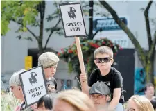  ?? JOHN RENNISON THE HAMILTON SPECTATOR ?? Two boys hold up signs saying they are members of Greta Thunberg’s army during the Fridays for Future climate protest in Gore Park Friday.