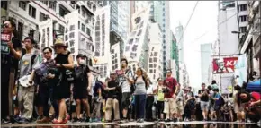  ?? ISAAC LAWRENCE/AFP ?? People attend a protest march in Hong Kong on Saturday, coinciding with the 20th anniversar­y of the city’s handover from British to Chinese rule.