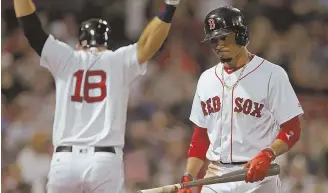  ?? STAFF PHOTO BY JOHN WILCOX ?? UNLUCKY: Mookie Betts reacts as he walks back to the dugout after striking out in the 13th inning last night at Fenway Park. The Red Sox won, 3-2, in 19 innings.