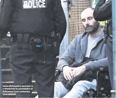  ?? COLM LENAGHAN ?? Jackie McDowell is escorted in a wheelchair by paramedics at Ballymena Court yesterday