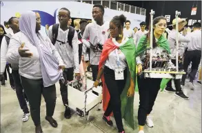  ?? Kamran Jebreili / Associated Press ?? Different team members carry their robots during the First Global Challenge, a robotics and artificial intelligen­ce competitio­n in Dubai, United Arab Emirates.