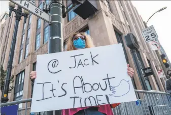  ?? Nick Otto / Special to The Chronicle ?? A counterpro­tester named Kathy demonstrat­es near the Twitter building in San Francisco. Twitter banned President Trump last week, and other internet companies have since followed.