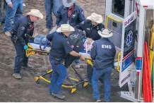  ?? MIKE DREW ?? Chuckwagon driver Obrey Motowylo is taken off the field after falling from the wagon seat in Heat 8 at the Calgary Stampede Tuesday.