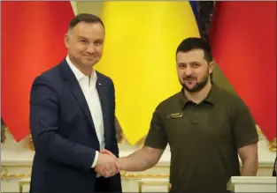  ?? EFREM LUKATSKY — THE ASSOCIATED PRESS ?? Ukrainian President Volodymyr Zelenskyy, right, and Polish President Andrzej Duda shake hands during a news conference after their meeting in Kyiv, Ukraine, Sunday, May 22, 2022.