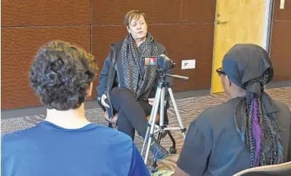  ?? KENNETH K. LAM/BALTIMORE SUN ?? Lydia Wilkins, who was 11 years old when she helped integrate Gwynn Oak Amusement Park in Baltimore County in 1963, is interviewe­d by students from City Neighbors High School and the Park School of Baltimore at the Reginald F. Lewis Museum.