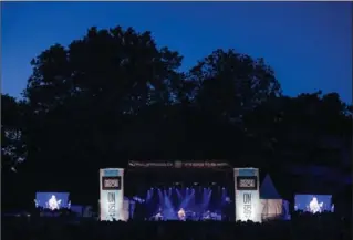  ??  ?? Dusk falls on a headliner: A new main stage was set up just south of the fountain. The stage banner said it all: For the stars and the crowd, it felt good to be back in Gage Park.