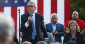  ?? John Minchillo/ Associated Press ?? Ohio Gov. Mike DeWine, left, speaks alongside Dayton Mayor Nan Whaley, right, during a vigil after a mass shooting on Sunday in Dayton, Ohio.