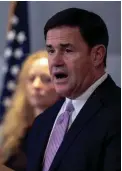  ??  ?? Gov. Doug Ducey addresses reporters March 11 at the Arizona State Public Health Laboratory in Phoenix regarding COVID-19 and Arizona’s preparedne­ss efforts. Ducey declared a public health emergency after health officials, at that time, had announced a ninth case in the state.