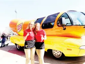  ??  ?? Maggie Thomas (right) and her copilot Molly Swindall (left) will be rolling into Starkville in the famous Oscar Mayer Wienermobi­le on Tuesday. (Submitted photo)