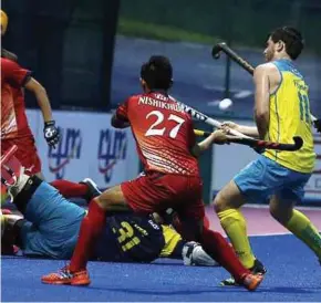  ??  ?? Japanese and Australian players in action in the Sultan of Johor Cup in Johor Baru yesterday.