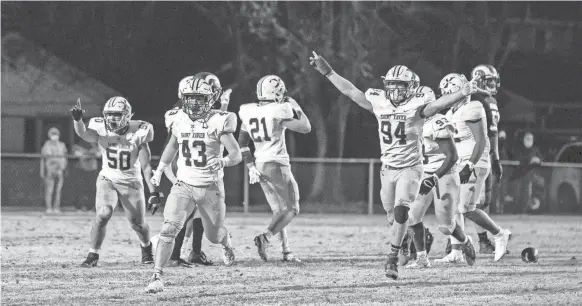  ?? JEFF FAUGHENDER/COURIER JOURNAL ?? St. Xavier players react and run off the field after stopping the final Manual drive as the Tigers defeated the Crimsons 10-6 in the second round of the Class 6A playoffs on Nov. 27.