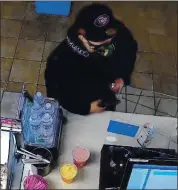  ?? PALO ALTO POLICE DEPARTMENT ?? Security video shows a man who robbed at gunpoint a Baskin Robbins on Middlefiel­d Road in Palo Alto on Monday.