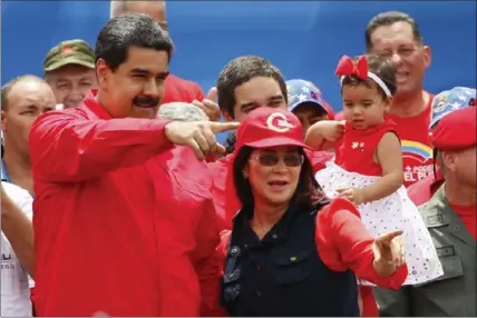  ?? ARIANA CUBILLOS, THE ASSOCIATED PRESS ?? Venezuela’s President Nicolas Maduro, left, and his wife Cilia Flores, right, greet supporters upon their arrival to rally in Caracas, Venezuela, Thursday.